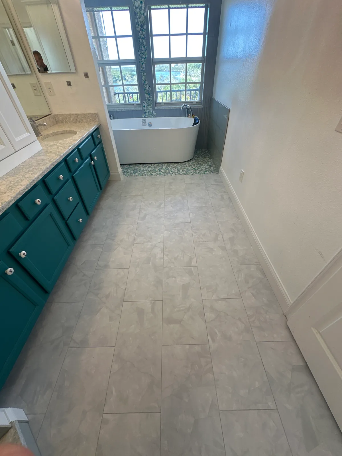 Herringbone tile floor in a transitional Tampa Bay bathroom