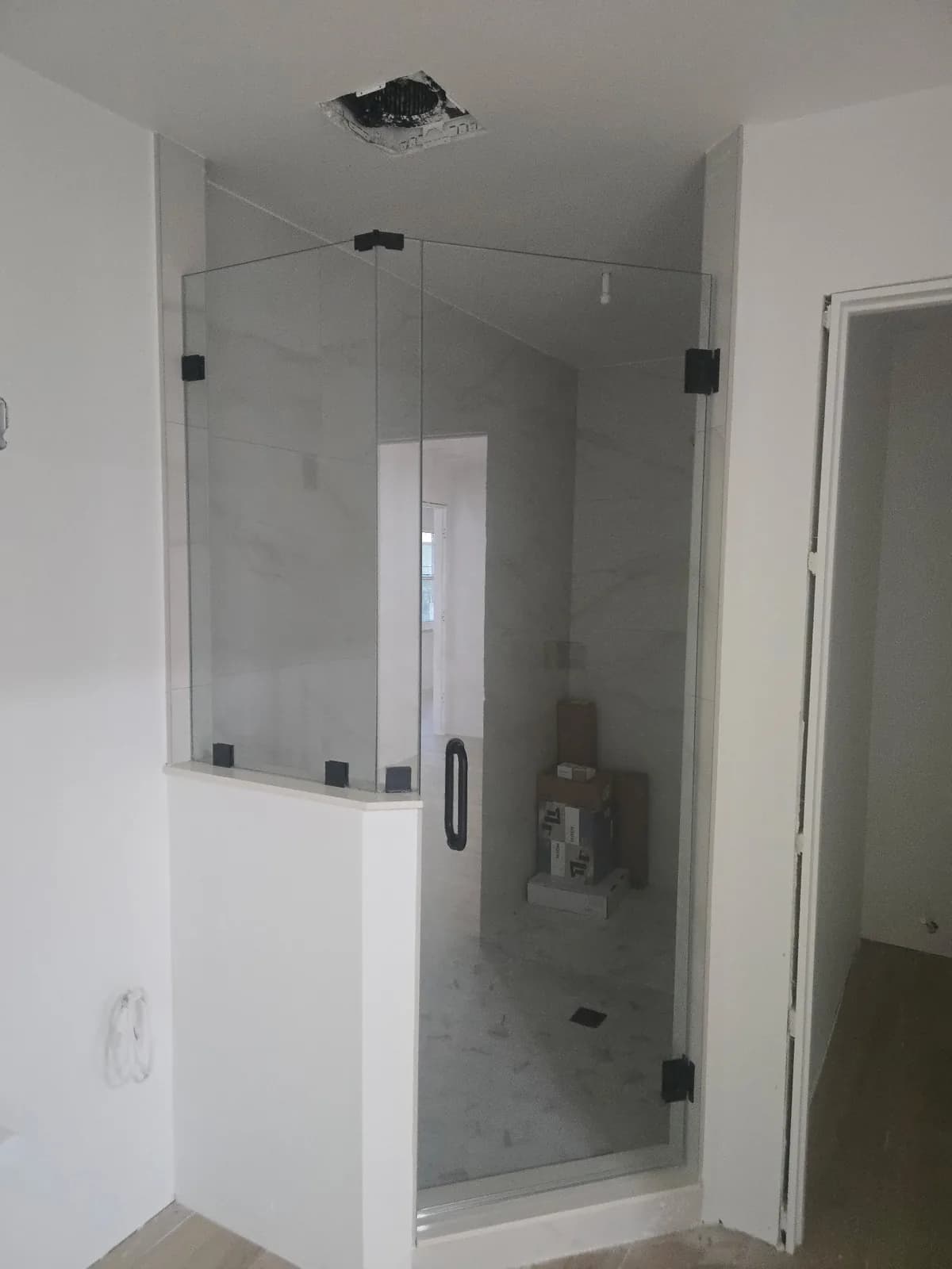 Large format porcelain slab in a curbless walk in shower