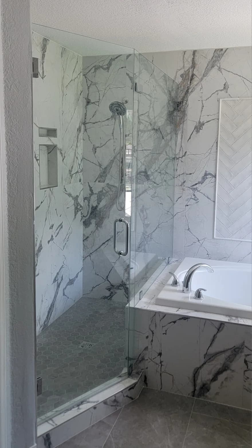 Curbless walk in shower with linear drain and large format porcelain wall