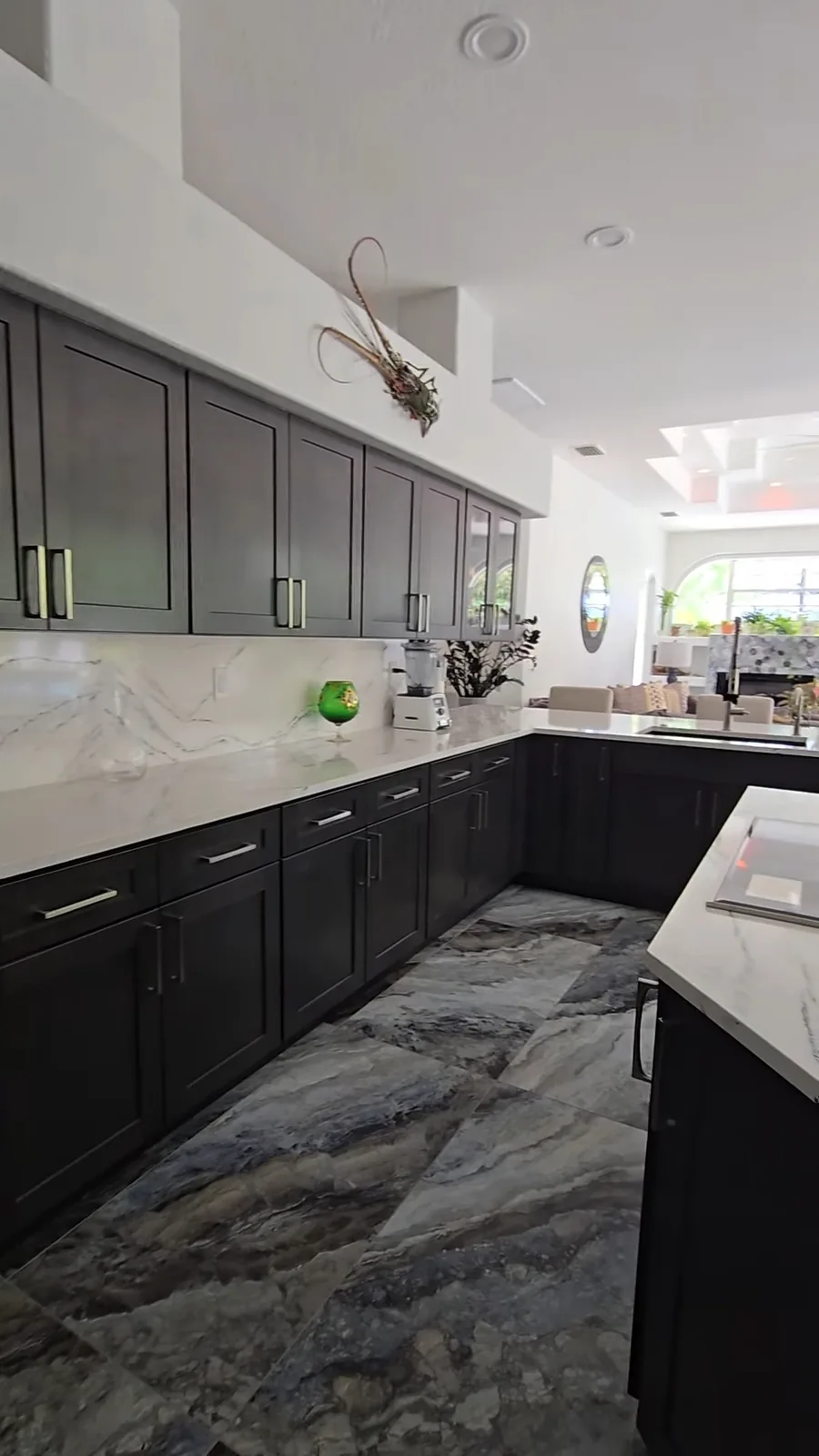 Espresso shaker kitchen with calacatta marble backsplash and dramatic blue marble floor tile